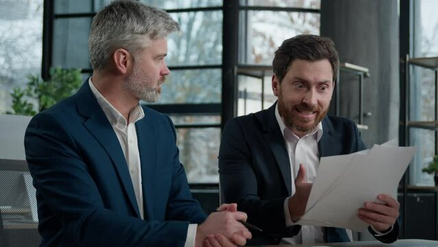 Two disgruntled furious Caucasian businessmen arguing about bad contract in office men colleagues partners dispute incorrect document failed transaction deal conflict problem shouting break agreement