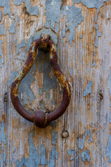 Weathered Wooden Door with Rusty Iron Knocker