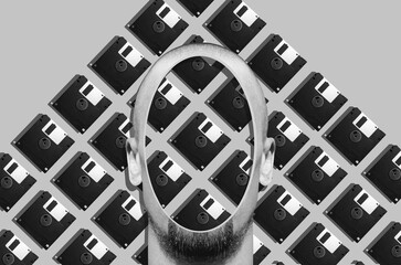Digital collage in surrealism style with head of a man and floppy disk on background	