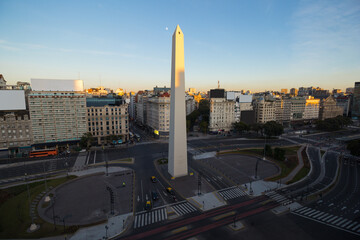 The iconic obelisk of Buenos Aires, Argentina, lit by sunrise. Aerial view of the skyline.