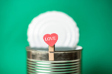 Former, forgotten love concept. Heart with the inscription love on the background of an open tin...