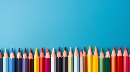 Colorful pencils on blue background. Back to school concept.