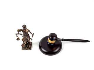 Bronze statue of Lady Justice and a judge's gavel on a white background. Statue of justice and judge's gavel close-up.