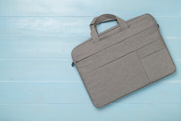Grey stylish laptop bag on wooden background,top view
