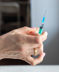 Close upshot of the woman preparing medicine for injection. Healthcare