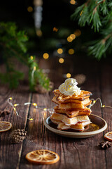 Belgian waffles with pine tree on background with Christmas light 