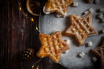 Belgian waffles with pine tree on background with Christmas light 