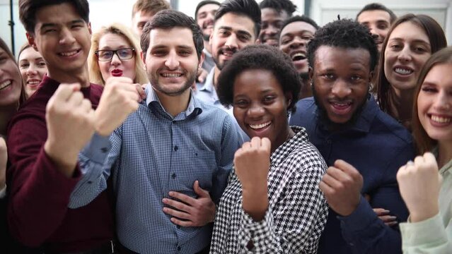 Confident diverse college students show fist up.