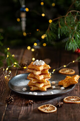 Belgian waffles with pine tree on background with Christmas light 