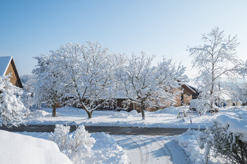 Country house and snow covered garden on a cold day morning