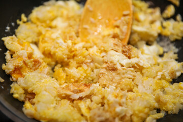 fried rice dish with vibrant vegetables and spices on a ceramic plate