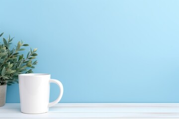  clean, white mug sits on a wooden table against a calming blue background, accompanied by a touch of greenery, epitomizing a peaceful beginning to the day.