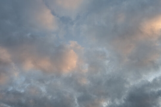 Cloudscape at golden hour with very soft  pink golden clouds.