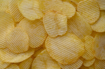 food background from delicious chips poured out of a pack 4