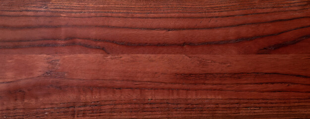 Rich Textured Red Walnut Wood Surface Close-up. Detailed view of red walnut wood showing the natural grain and warm tones perfect for furniture