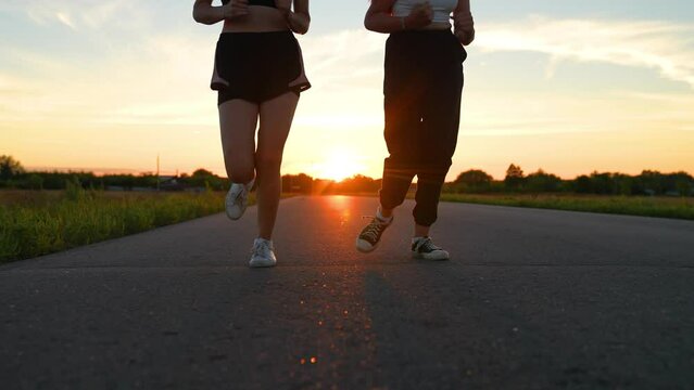 two friends running sunset, team group girls running sunset, silhouette athletic girls, teamwork legs athlete running road, training running health, club like-minded people, outdoor exercise, you can