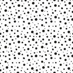 Organic black dots ranging in size on a white background seamless pattern. Stock vector for printing on different surfaces. 