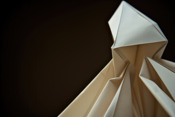 Extreme close-up of a simple, geometric paper origami figure.