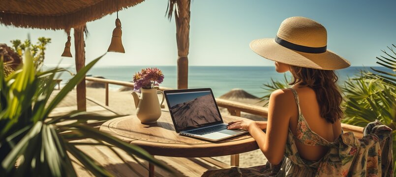 Young woman freelancer working on laptop at the beach, stay connected and productive during vacation