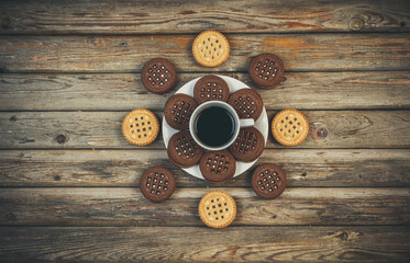 Round vanilla and chocolate cookies on wooden background