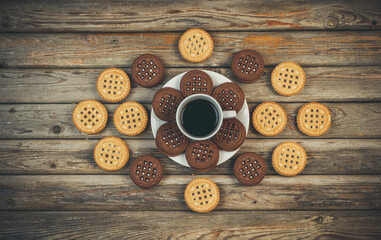 Round vanilla and chocolate cookies on wooden background