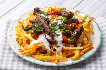 Turkish food; Cokertme Kebab - Beef meat kebab with yoghurt and french fries