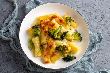 Pasta baked with broccoli and chicken. Broccoli, cheese and gratin sauce on baked penne pasta.
