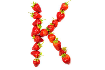 English letter K made from strawberries on a white background, letter made from red strawberries