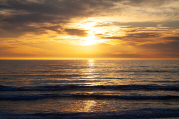 A spectacular amber colored sunset on Southern Oregon's Adventure Coast along historic and scenic Highway 101 in Gold Beach Oregon.