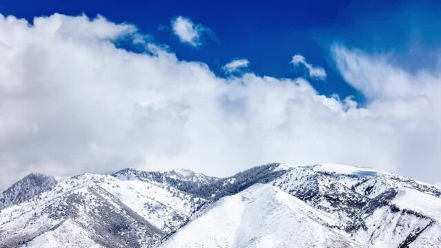 Time lapse of clouds over the snow covered Wasatch Mountains near Salt Lake City, Utah.
