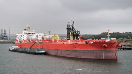 Very Large LNG Powered Crude Oil Carrier During Loading And Bunkering Operations In The Port. Crude...