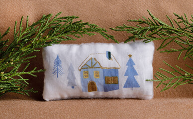 Little christmas cushion with cottage and pine tree branches