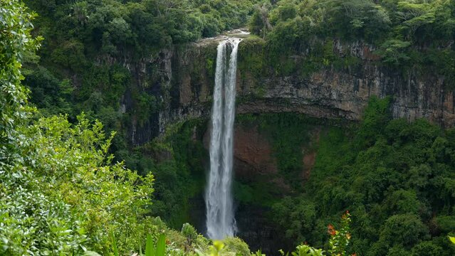 A breathtaking freehand capture of the majestic Chamarel Waterfalls in Mauritius, where a powerful twin cascade plunges into a lush tropical canyon surrounded by pristine emerald rainforest.