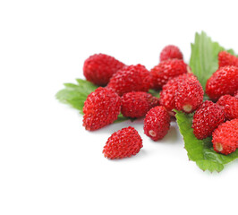 Ripe wild strawberries and green leaves isolated on white