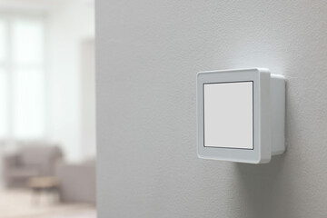 One thermostat on white wall indoors, space for text. Smart home system