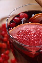 Aromatic mulled wine in glass on table, closeup