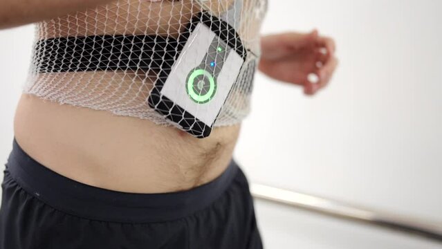 Video fo a cardiac Holter monitor hanging on a patient while performing a cardiac stress test