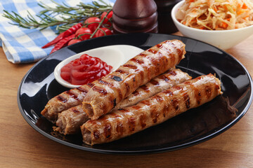 Grilled sausages with cabbage and sauce