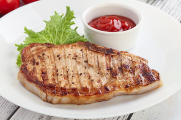 Grilled pork steak with ketchup