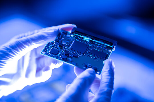 laboratory worker hands holding new circuit board, digital AI chip