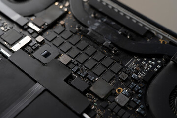 a disassembled laptop, close up shot, black circuit board of computer