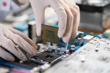 process of Installation of processor in CPU socket, hands in gloves holding chip