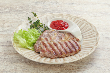 Grilled pork neck steak with ketchup