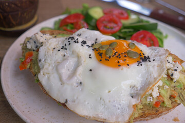  Egg and mushrooms on toast served with cherry tomato and greens 