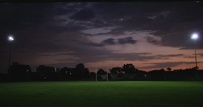 Rugby field, night and grass for sports ground with lights and stadium for fitness location in city. Place, pitch and exercise with training club with professional and athlete to train and develop