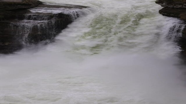 Vertical movie of a waterfall.. River Doubs is natural border between Switzerland and France in Jura. Big amount of water falling 27 m down a cascade.	
