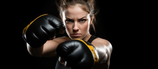 Female Boxer MMA fighter posing with black gloves. - obrazy, fototapety, plakaty