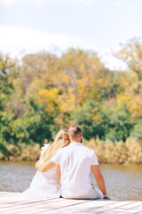 Couple kissing in the park. Happy newlyweds near the house