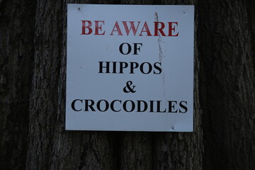 be aware of hippos and crocodiles sign