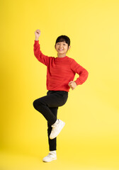 Fototapeta na wymiar full body Image of Asian girl wearing a sweater posing on a yellow background